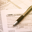 Image of tax forms with pen.