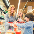 Image of mother and children grocery shopping.