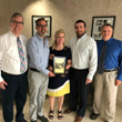 Picture of The Bank of Elk River employees with members of Elk River Parks and Recreation. The Bank of Elk River accepts plaque for partnering with the city.