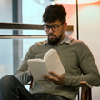 Image of man reading a book.